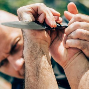 person trying to disarm someone with knife