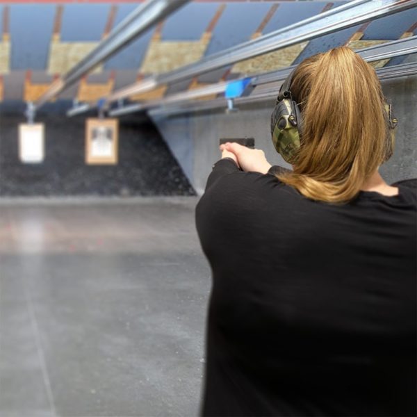 lady pointing a gun at target